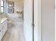 Bathroom with a marble topped vanity, framed pictures and tan towels at 15021 Oxford Grey Dr, Lakewood Ranch, FL 34211