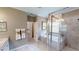 Bright bathroom featuring a soaking tub, walk-in shower with glass door, and double sink vanity at 15021 Oxford Grey Dr, Lakewood Ranch, FL 34211