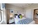 Stylish bedroom with decorative lighting, patterned curtains, white furniture, and a bed with blue accents at 15021 Oxford Grey Dr, Lakewood Ranch, FL 34211