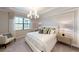 Bedroom featuring neutral tones, large windows, and a contemporary chandelier at 15021 Oxford Grey Dr, Lakewood Ranch, FL 34211