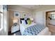 Cozy bedroom with stylish blue decor, featuring a comfortable bed, white linens, and recessed lights at 15021 Oxford Grey Dr, Lakewood Ranch, FL 34211