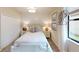 Relaxing bedroom with shiplap accent wall, stylish nightstands and a modern ceiling light at 15021 Oxford Grey Dr, Lakewood Ranch, FL 34211
