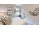 Bedroom with neutral decor, plush bedding, designer accents, and views to an attached bathroom at 15021 Oxford Grey Dr, Lakewood Ranch, FL 34211