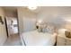 Cozy bedroom featuring stylish white shiplap accent wall and a comfortable bed with decorative pillows at 15021 Oxford Grey Dr, Lakewood Ranch, FL 34211