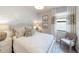 Calm bedroom with natural light, a shiplap wall, and minimalist wall art at 15021 Oxford Grey Dr, Lakewood Ranch, FL 34211
