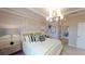 Elegant bedroom features stylish furniture, a coffered ceiling, and decorous bedside tables with lamps at 15021 Oxford Grey Dr, Lakewood Ranch, FL 34211