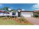Stunning single-Gathering home with lush landscaping, barrel tile roof, and charming curb appeal in a desirable community at 15021 Oxford Grey Dr, Lakewood Ranch, FL 34211
