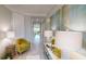 Bright hallway with neutral colors and decor, leading to multiple rooms and features a large decorative art piece at 15021 Oxford Grey Dr, Lakewood Ranch, FL 34211