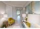Bright hallway with neutral colors and decor, leading to multiple rooms and features a large decorative art piece at 15021 Oxford Grey Dr, Lakewood Ranch, FL 34211