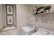 Functional laundry room with modern washer and dryer, complemented by decorative shelving and artwork at 15021 Oxford Grey Dr, Lakewood Ranch, FL 34211