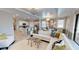 Open-concept living area boasts modern decor, a large sectional sofa, and access to kitchen and dining spaces at 15021 Oxford Grey Dr, Lakewood Ranch, FL 34211