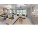 Bright living room with stylish decor, featuring a comfortable sectional sofa and elegant lighting at 15021 Oxford Grey Dr, Lakewood Ranch, FL 34211