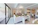 Spacious living room featuring modern white furniture, stylish decor, and access to outdoor space at 15021 Oxford Grey Dr, Lakewood Ranch, FL 34211