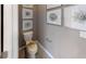 Powder room with elegant framed botanical artwork on the walls and a neutral color palette at 15021 Oxford Grey Dr, Lakewood Ranch, FL 34211
