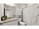 Well-lit bathroom with a shower and tub combination, a granite countertop, and neutral color palette at 15107 Oxford Grey Dr, Bradenton, FL 34211