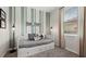 Stylish bedroom featuring a daybed, striped accent wall, and soft carpet at 15107 Oxford Grey Dr, Bradenton, FL 34211