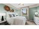 Calming bedroom with muted green walls, soft carpet, a ceiling fan, and a bright window at 15107 Oxford Grey Dr, Bradenton, FL 34211