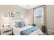 Cozy bedroom featuring a queen bed, decorative pillows, and a view of the outdoors at 15107 Oxford Grey Dr, Bradenton, FL 34211