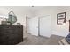 Stylish bedroom with soft carpet, open doorways and two large closets at 15107 Oxford Grey Dr, Bradenton, FL 34211