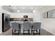 Modern kitchen featuring white cabinets, stainless steel appliances, and a granite island with seating at 15107 Oxford Grey Dr, Bradenton, FL 34211