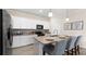 Well-lit kitchen featuring granite countertops, modern appliances, and an island with seating at 15107 Oxford Grey Dr, Bradenton, FL 34211