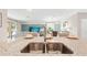 Open concept kitchen with stainless sink, granite counters, and views into the living room and dining area at 15107 Oxford Grey Dr, Bradenton, FL 34211