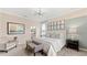 Well-lit bedroom with coordinated decor, crown molding, accent wall and furniture arrangement at 15107 Oxford Grey Dr, Bradenton, FL 34211