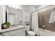 Bathroom featuring granite counters, white cabinets, tiled shower, and modern fixtures at 15127 Oxford Grey Dr, Bradenton, FL 34211