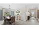 Dining area boasts a modern chandelier, a decorative mirror, and is connected to a hallway for easy access at 15127 Oxford Grey Dr, Bradenton, FL 34211