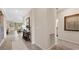 Hallway featuring tile floors, a view of the Gathering room and dining area, and neutral paint at 15127 Oxford Grey Dr, Bradenton, FL 34211