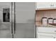 Stainless steel refrigerator with water dispenser, granite counters, and white cabinets at 15127 Oxford Grey Dr, Bradenton, FL 34211