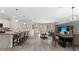 Open-concept living space features a kitchen island, dining area, and living area with modern finishes and sliding glass doors at 15127 Oxford Grey Dr, Bradenton, FL 34211