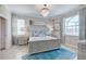 Serene bedroom featuring a plush blue rug, decorative molding, and a crystal chandelier at 15135 Oxford Grey Dr, Bradenton, FL 34211