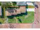 Aerial view of the property showcasing the home, landscaping, and lot size at 1794 Santa Barbara Dr, Dunedin, FL 34698