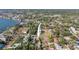 An aerial view of the property in a neighborhood with mature trees and lush surroundings at 1794 Santa Barbara Dr, Dunedin, FL 34698