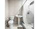 Traditional bathroom featuring a white toilet, pedestal sink, and marble tile shower at 1794 Santa Barbara Dr, Dunedin, FL 34698