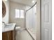 Stylish bathroom featuring a modern vanity, round mirror, and walk-in shower at 1794 Santa Barbara Dr, Dunedin, FL 34698