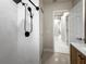 Modern shower and adjacent hallway entry is showcased in this bathroom at 1794 Santa Barbara Dr, Dunedin, FL 34698