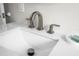 Close up of a bathroom sink featuring modern faucet fixture, bright white countertop, and soap dish at 1794 Santa Barbara Dr, Dunedin, FL 34698