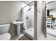 Bathroom with a pedestal sink and walk-in shower at 1794 Santa Barbara Dr, Dunedin, FL 34698