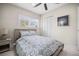 Cozy bedroom with natural light from the window, a ceiling fan, and painted with neutral colors at 1794 Santa Barbara Dr, Dunedin, FL 34698