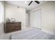 This bedroom has neutral walls, a ceiling fan, and closet with louvered doors at 1794 Santa Barbara Dr, Dunedin, FL 34698