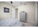 Bright bedroom featuring whitewashed wood-look floors and blue and grey furnishings at 1794 Santa Barbara Dr, Dunedin, FL 34698