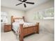 Bright bedroom featuring a wooden bed frame, ceiling fan, and natural light from the window at 1794 Santa Barbara Dr, Dunedin, FL 34698