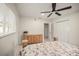 Bedroom with bright natural light, hardwood floors, and a closet with louvered doors at 1794 Santa Barbara Dr, Dunedin, FL 34698