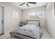 Bedroom features neutral decor, a ceiling fan, and light-filled with natural light at 1794 Santa Barbara Dr, Dunedin, FL 34698
