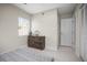 Bedroom with neutral paint, wood-look floors, and modern six-drawer dresser for storage at 1794 Santa Barbara Dr, Dunedin, FL 34698