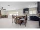Open-concept dining area seamlessly connects to the modern kitchen with a large fireplace in view at 1794 Santa Barbara Dr, Dunedin, FL 34698