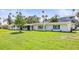 Beautiful home with a green lawn, blue shutters, and a freshly painted exterior at 1794 Santa Barbara Dr, Dunedin, FL 34698
