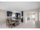 Open concept kitchen and dining area with stainless steel appliances, dark blue cabinets, and a wooden dining table at 1794 Santa Barbara Dr, Dunedin, FL 34698